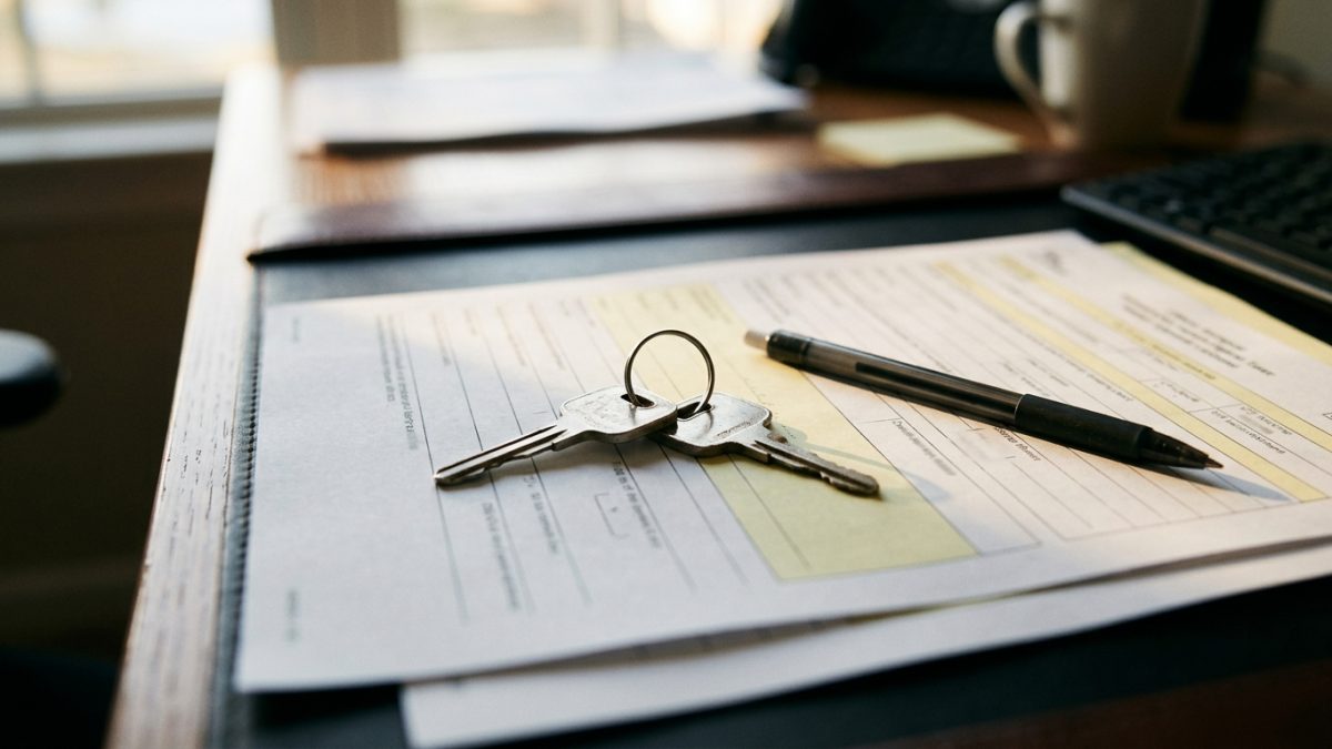 Motorcycle ignition key set placed on official handover paperwork