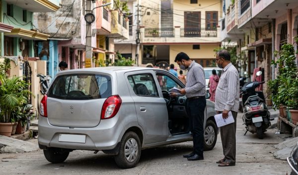 Car buyer verifying documents to check vehicle history India